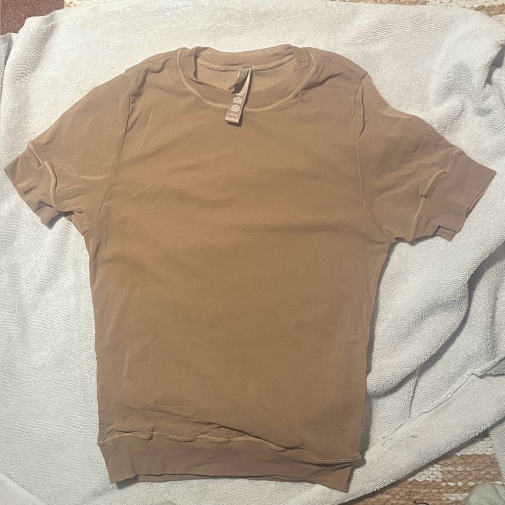 Skims mesh shirt. Thin and tight.